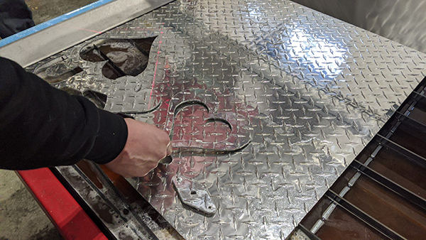 Mark Obannon a plumber in Nantucket using his new Swift-Cut Pro CNC plasma metal cutting table to cut out shape from a metal sheet