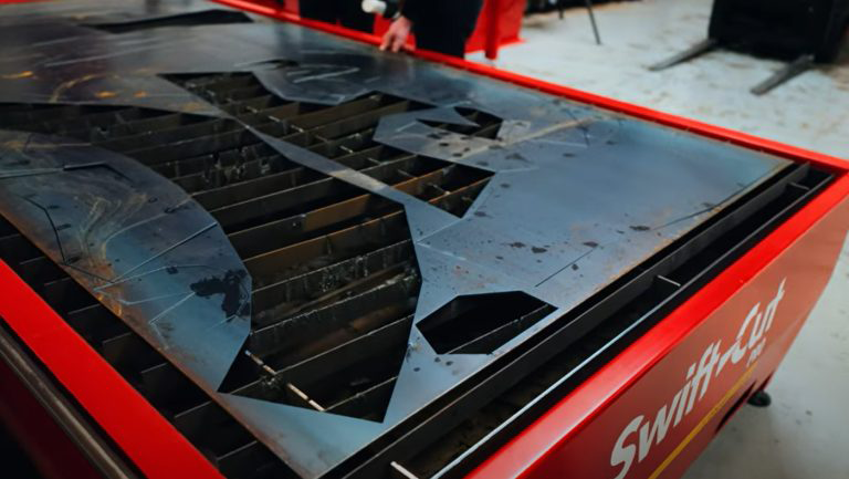 Nate's Forge using Swift-Cut Pro Plasma Cutting Table at Swift-Cut Headquarters Demo Suite to cut pieces for 10ft cat sculpture - Photo of 3mm mild steel sheet with piece cut out.