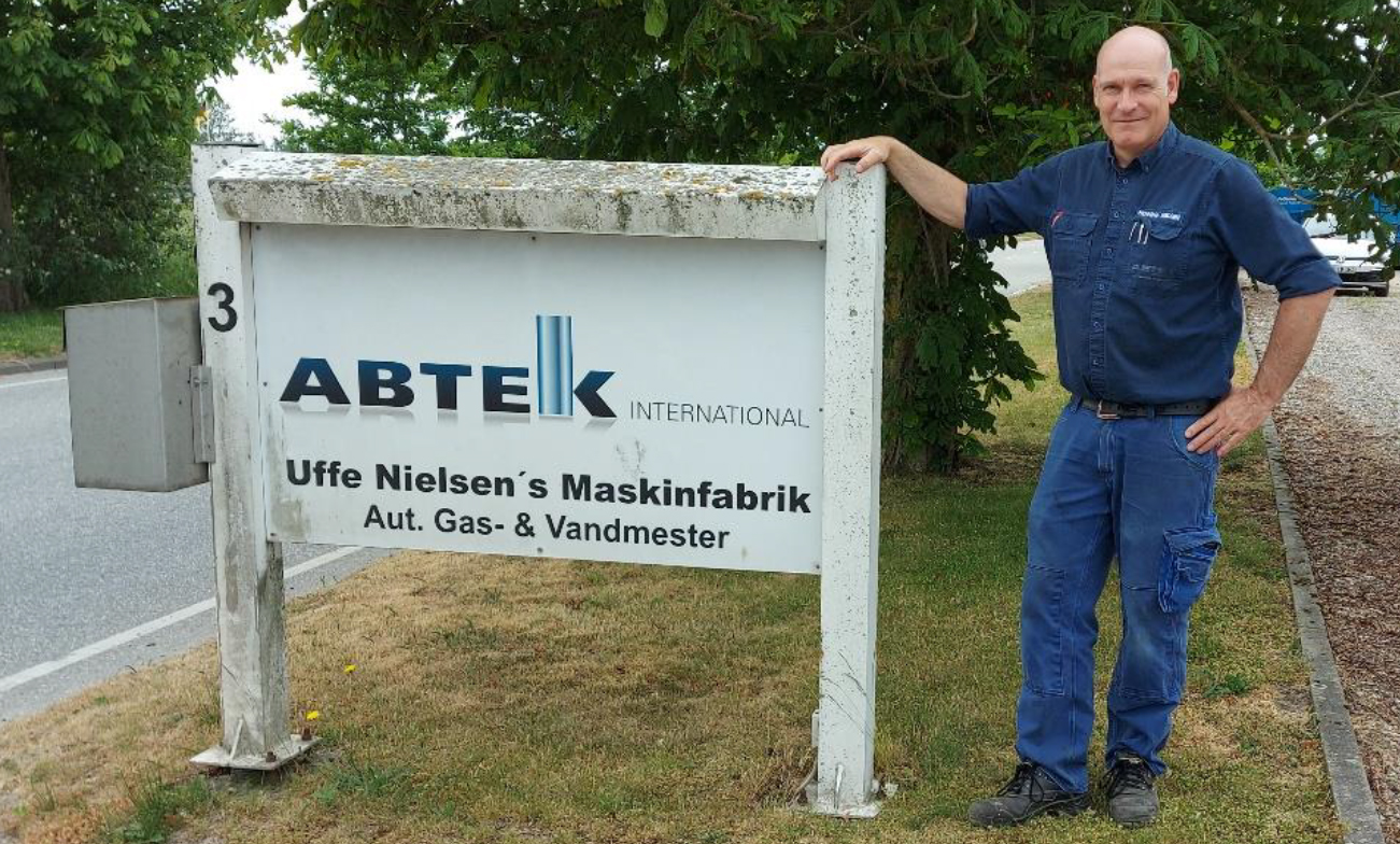 ABTEK INTERNATIONAL Owner Henning Nielsen standing in front of company sign