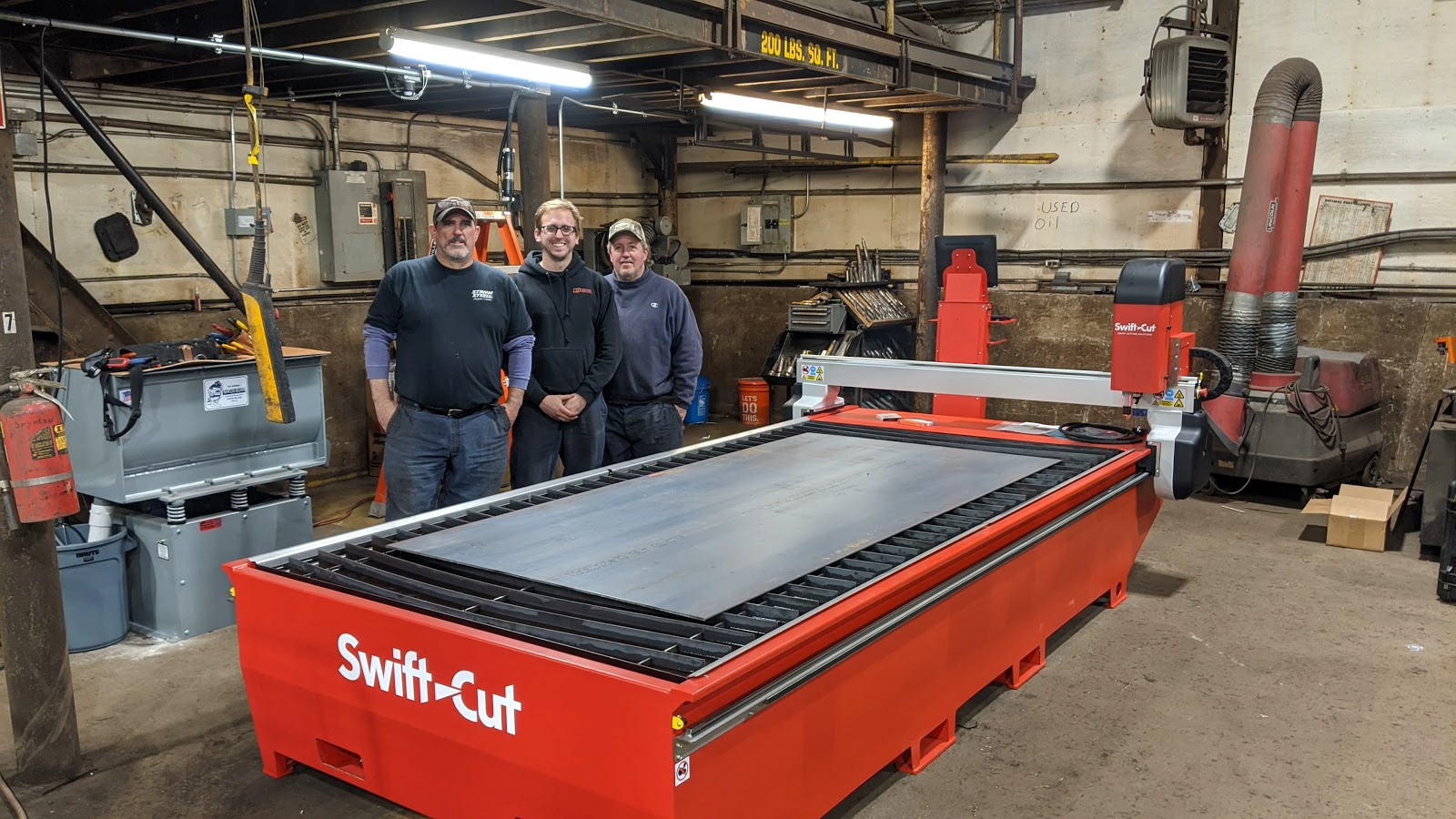 Stiman Steel Staff standing next to Swift=Cut Pro CNC plasma Cutting Table