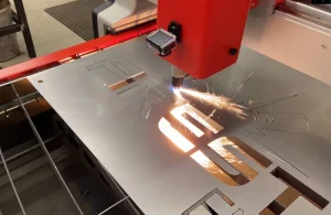 Firestorm Engineering using Swift-Cut Pro CNC plasma cutting table cutting out logo on sheet metal